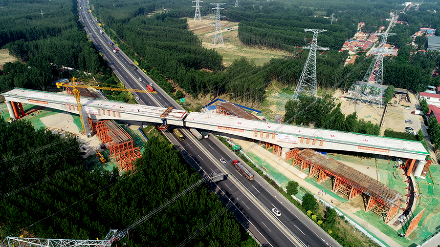 京雄城際鐵路跨廊涿高速轉體連續梁應用BIM（建筑信息模型）與信息化技術、支架數據傳輸和自動監測預警信息化平臺、大體積混凝土溫度自動監控信息化平臺、預應力管道整體定位鋼架等技術，提高了連續梁施工安全質量管理水平。圖為轉體進行中。