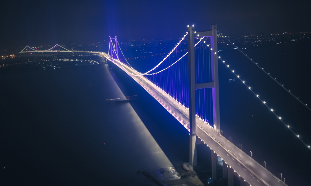 3月21日，虎門二橋項目實施全線調試亮燈，如不受雨水干擾預計在清明節前通車。虎門二橋是粵港澳大灣區核心區新的重要過江通道，建成通車后，從廣州南部到東莞的路程可縮短10公里，比現在縮短約半小時車程。圖為虎門二橋項目夜景。