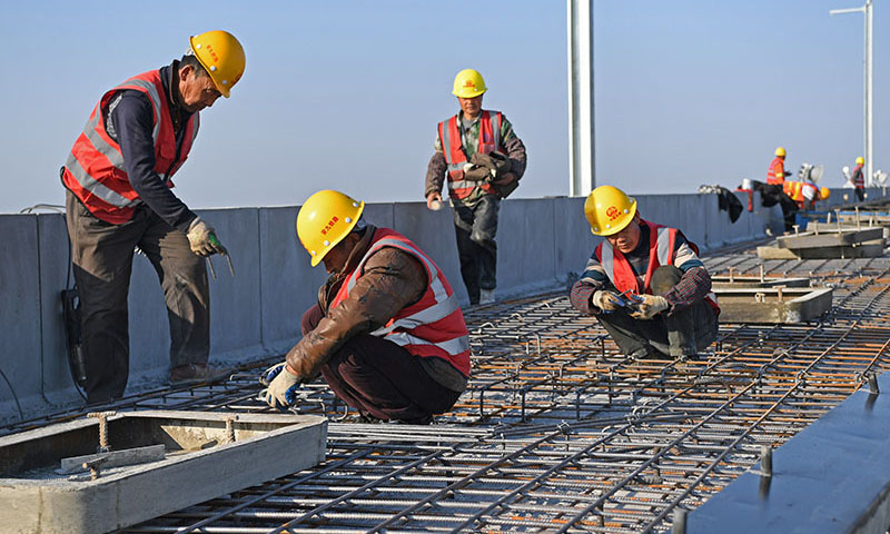 近日，安九高鐵江西段節后全面復工，各施工單位加快建設進度，確保完成工程目標。安九高鐵連接安徽省安慶市與江西省九江市，是國家中長期鐵路網規劃“八縱八橫”高速鐵路主要通道京港（臺）通道的重要組成部分，設計時速350公里。圖為2月20日，中鐵四局的建筑工人在安九高鐵江西段長江特大橋建設現場鋪設鋼筋模板。（新華社記者 萬象 攝）