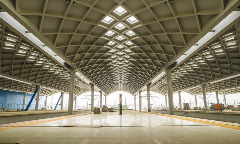 由于鄭州南站雨棚跨度大、空間造型變化多，施工工藝極其復雜，當時在全國沒有成品可以參考，為了快速高效推進雨棚施工進度，中鐵建工項目部創立了“清水混凝土雨棚創新工作室”，開展技術攻關，創新了承插式轉換裝置、弧面疊合板堆放運輸工裝及可調節斜向支撐等一系列輔助裝置，有效解決了雨棚施工過程中的難題，獲得實用新型專利5項、省級工法1項。圖為內部雨棚成品。