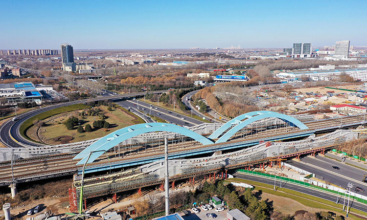 濟鄭高鐵是國家“八縱八橫”高鐵網的重要組成部分。項目通車后，濟南到鄭州的通行時間將縮短至1.5小時，將成為中原城市群與山東半島城市群間的快速客運通道。圖為12月22日，中鐵十局的工作人員在對濟鄭高鐵跨濟南經十西路槽型梁進行合龍作業（無人機照片）。新華社記者 郭緒雷 攝