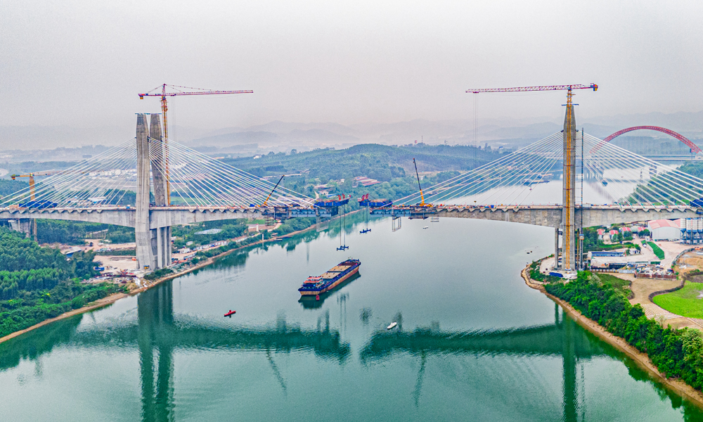 近日，南寧至深圳高速鐵路重點控制性工程——六律邕江特大橋最后一塊鋼梁完成吊裝焊接，標志著由中國鐵建所屬中鐵十四局承建的國內在建高鐵最大跨徑鋼混矮塔斜拉橋順利合龍。圖為合龍現場航拍。